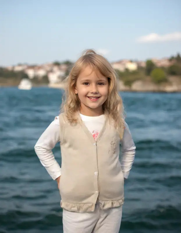 Yelekli gülümseyen sarışın kız.